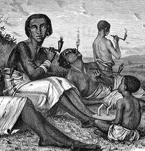 Young women of Kazeh in Tanzania smoking a pipe