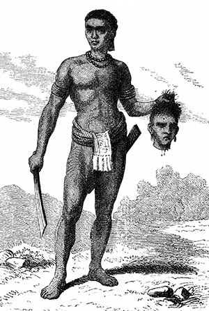 Borneo — Un guerriero dayak tiene la testa di un nemico ucciso.